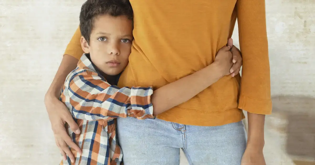 Child hugging their mother around the waist